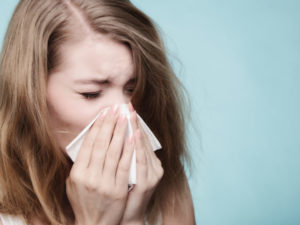 Vigilant Sneezing Woman Due To Allergy Shutterstock 247148017 E1497407399521